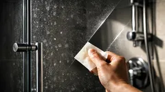 The parchment paper trick that removes hard water stains from shower fixtures